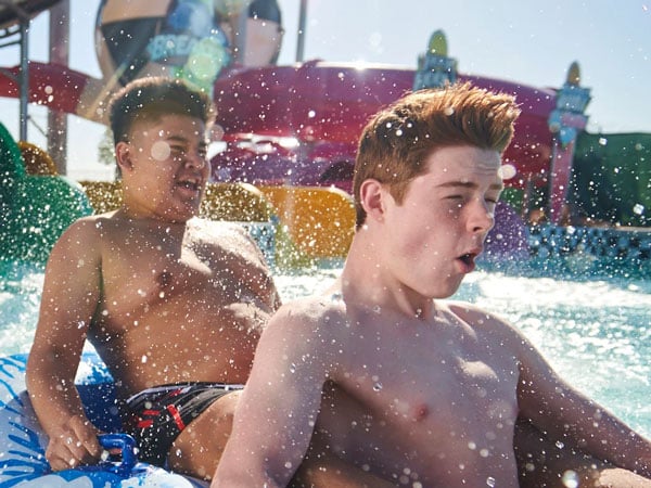 Boys on a water slide.
